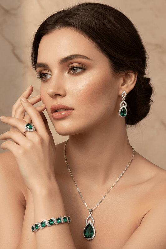 Luxury Zircon Necklace, Earrings & Ring Jewelry Set by CJ | 0 from Luxe Lane | SKU: CJLX246915201AZ | Barcode:  | Options: Green | Woman wearing emerald jewelry including earrings, necklace, and bracelet against a beige background