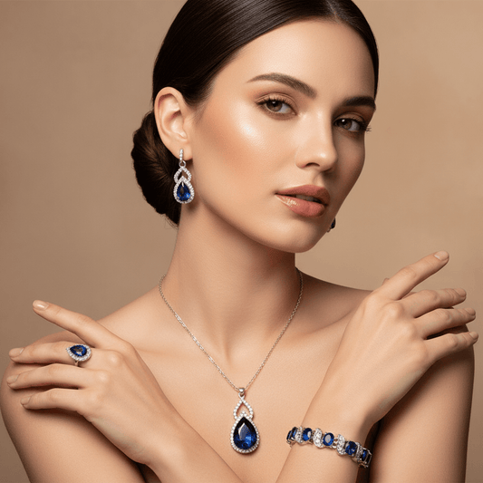 Luxury Zircon Necklace, Earrings & Ring Jewelry Set by CJ | 0 from Luxe Lane | SKU: CJLX246915201AZ | Barcode:  | Options: Green | Woman wearing blue gemstone jewelry including earrings, necklace, ring, and bracelet on a beige background