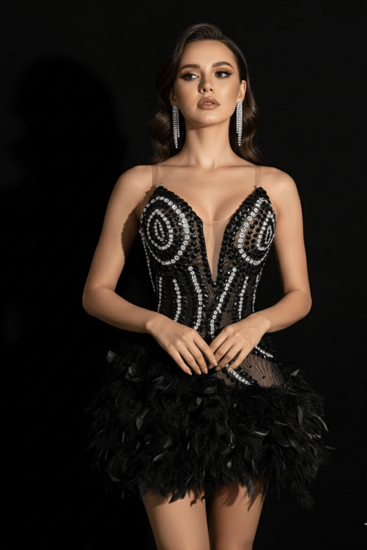 Noctura Feather Rhinestone Mini Dress by Shine | from Luxe Lane | SKU:  | Barcode:  | Options: Black S | Woman wearing a black sequin and feather dress against a black background