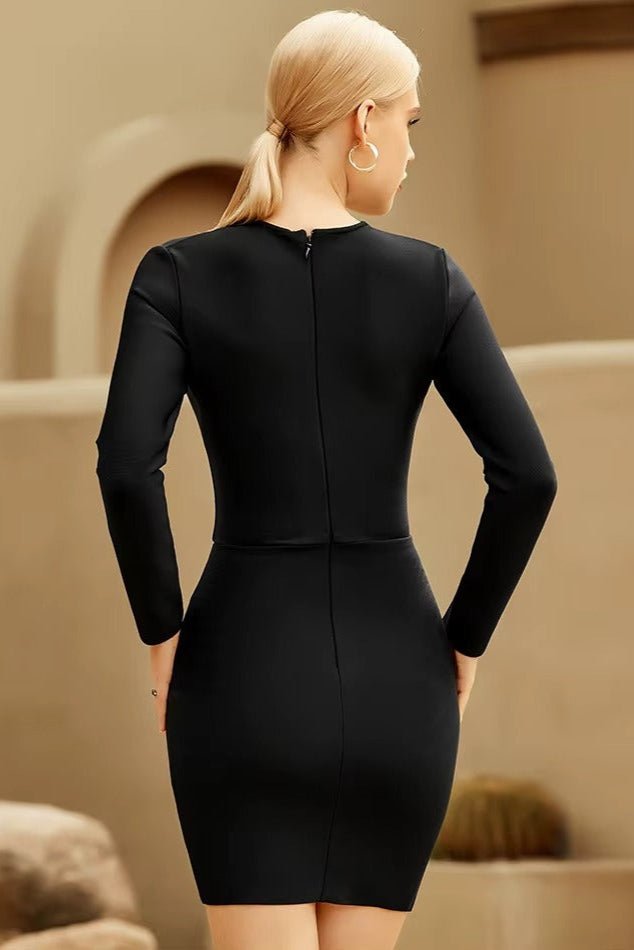 Nova Mesh Diamond Mini Dress by Luxe Lane | from Luxe Lane | SKU:  | Barcode:  | Options: Black XS | Woman wearing a black dress standing in an outdoor setting with beige walls.