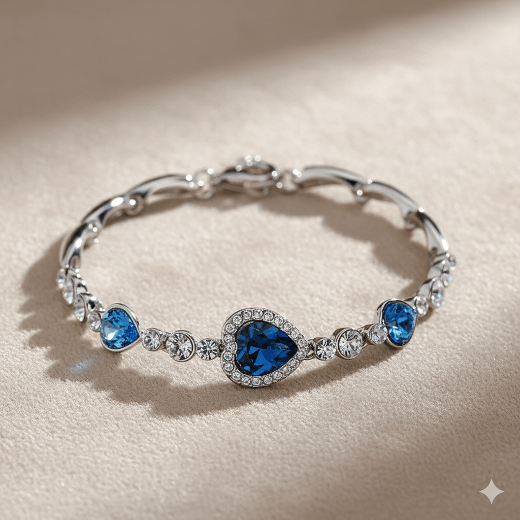 Ocean Heart Necklace & Earring Set by CJ | 0 from Luxe Lane | SKU: CJLX143524601AZ | Barcode:  | Options: Bracelet & Earrings Set | Silver bracelet with blue gemstones on a beige background