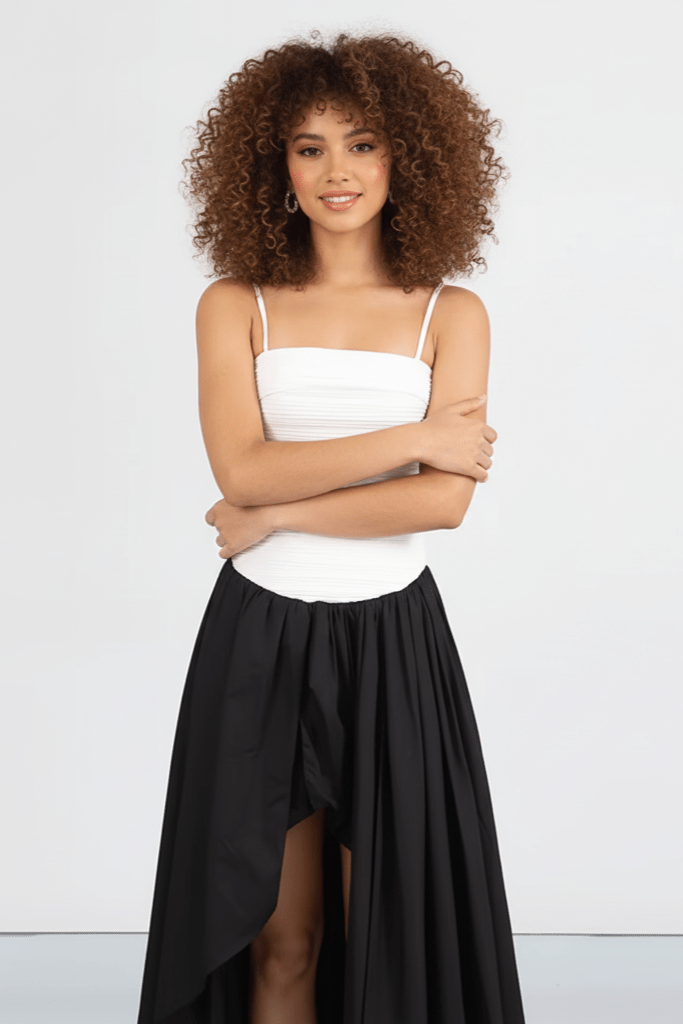 Pleated Corset Maxi Gown by Luxe Lane | from Luxe Lane | SKU:  | Barcode:  | Options: Black S | Woman wearing a white top and black skirt on a light gray background