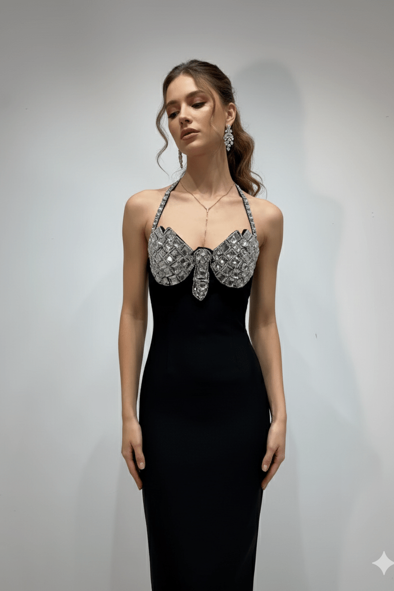 Rhinestone Butterfly Halter Bandage Maxi Dress by Luxe Lane | heath gown from Luxe Lane | SKU: -1 | Barcode:  | Options: Black XS(4) | Woman wearing a black evening gown with a silver bow detail against a plain background