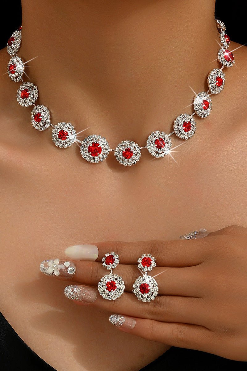 Round Rhinestone Quartz Necklace & Earrings Set by CJ | 0 from Luxe Lane | SKU: CJLX246901901AZ | Barcode:  | Options: White | Jewelry set with necklace, earrings, and ring featuring red gemstones on a model.