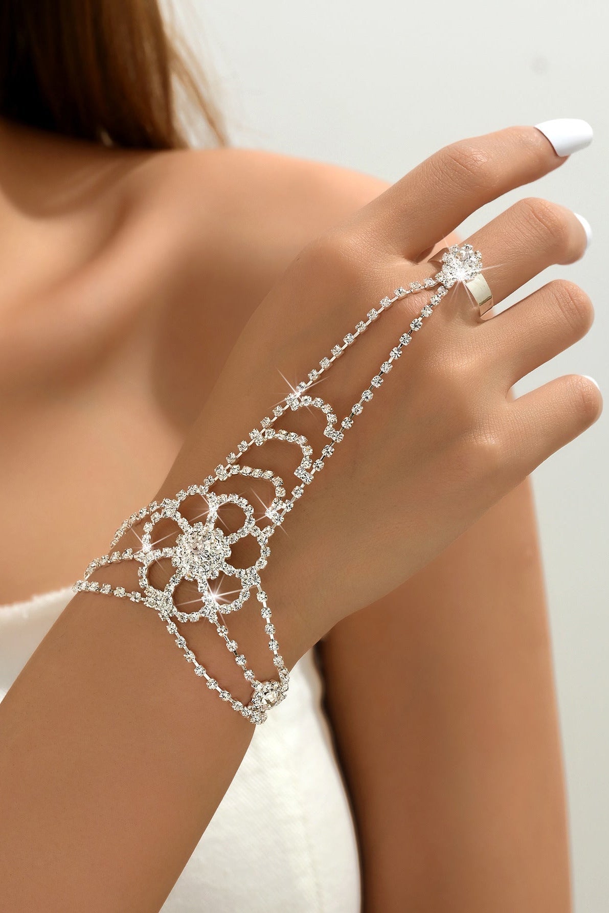 Round Rhinestone Quartz Necklace & Earrings Set by CJ | 0 from Luxe Lane | SKU: CJLX246901906FU | Barcode:  | Options: Finger Chain | Silver bracelet and ring on a hand against a neutral background