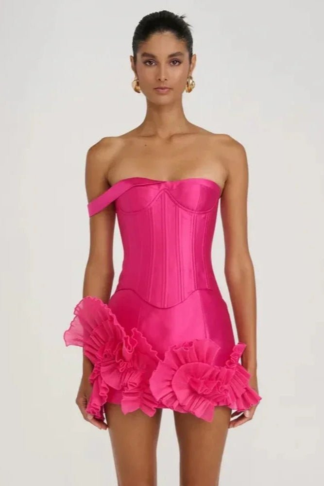 Satin Asymmetrical Mini Dress by Luxe Lane | from Luxe Lane | SKU:  | Barcode:  | Options: S | Model wearing a bright pink strapless dress with ruffled details on a plain background