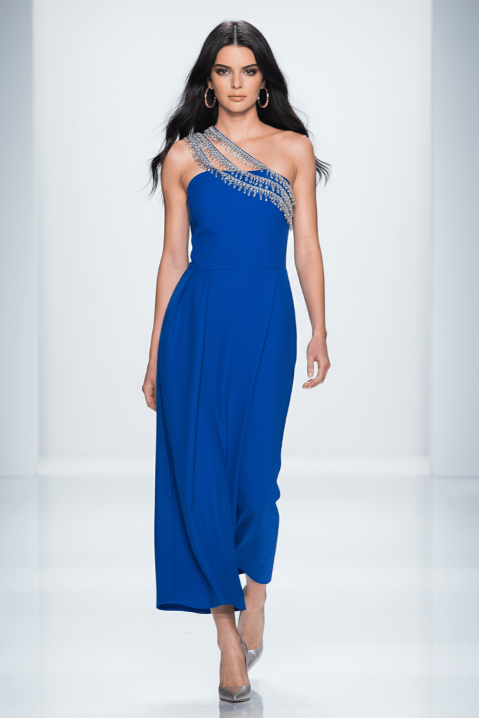 Seraphine One - Shoulder Rhinestone Maxi Gown by Shine | heath gown from Luxe Lane | SKU: -1 | Barcode:  | Options: Blue S | Model wearing a blue evening gown with intricate detailing on a white background