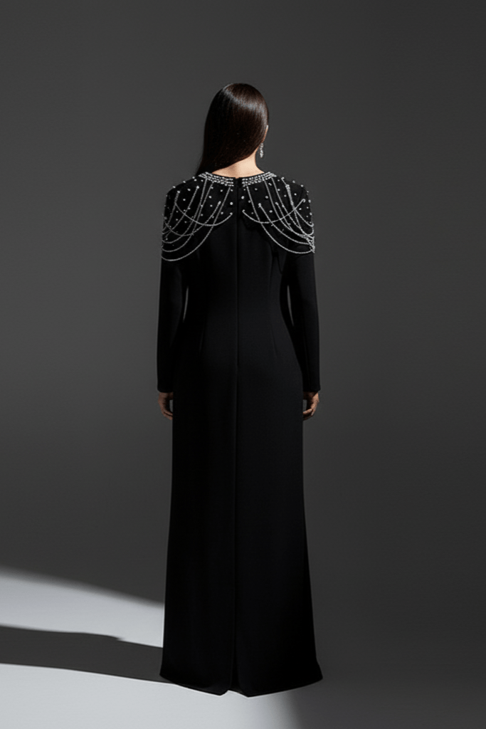 Valentina Embellished Evening Gown by Luxe Lane | Formal Gown from Luxe Lane | SKU:  | Barcode:  | Options: Black S | Woman wearing a black evening gown with beaded shoulder details on a gray background