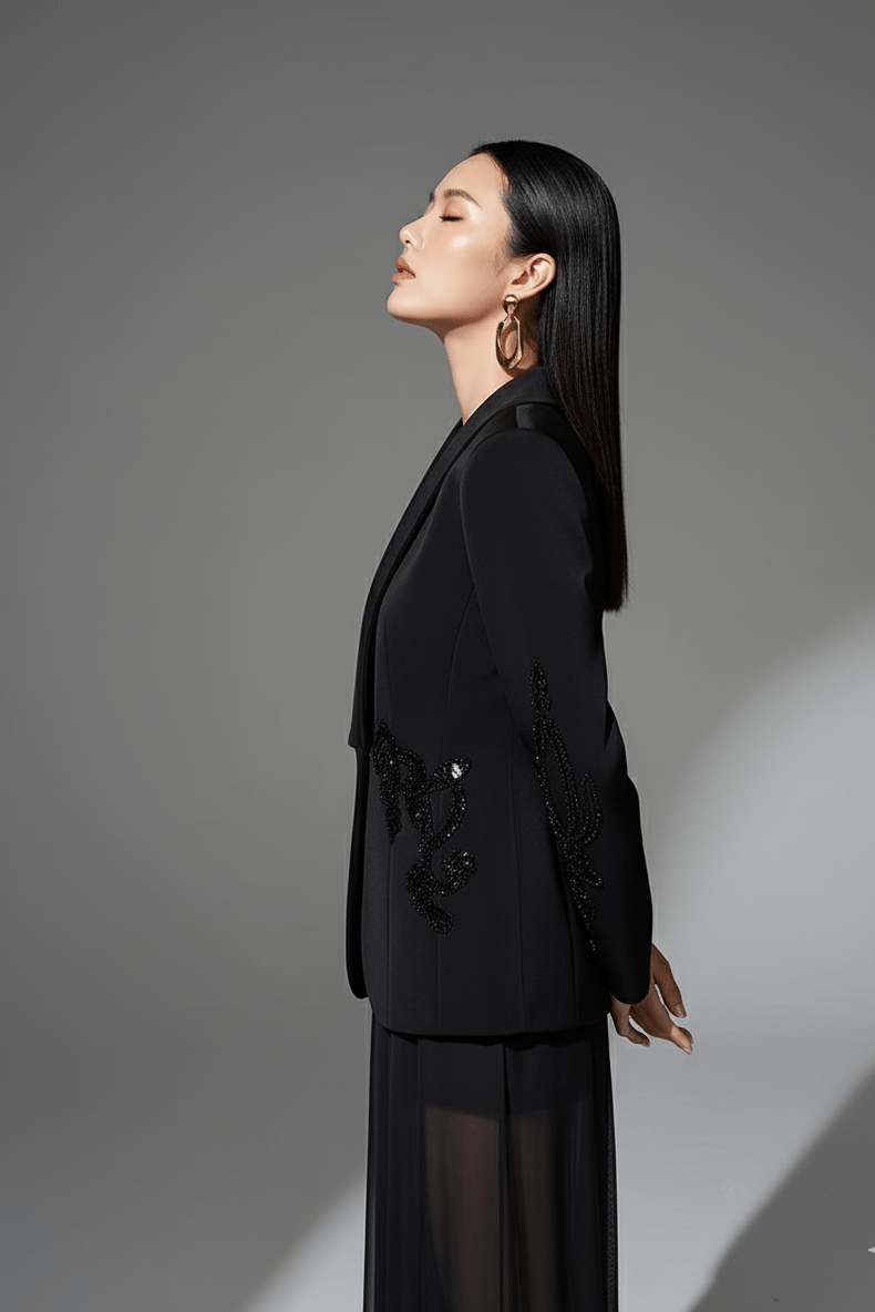 Veyra Sequin Blazer & Sheer Pants Set by Shine | 2 piece long set from Luxe Lane | SKU: -1 | Barcode:  | Options: Black S | Woman wearing a black outfit with sheer elements on a gray background