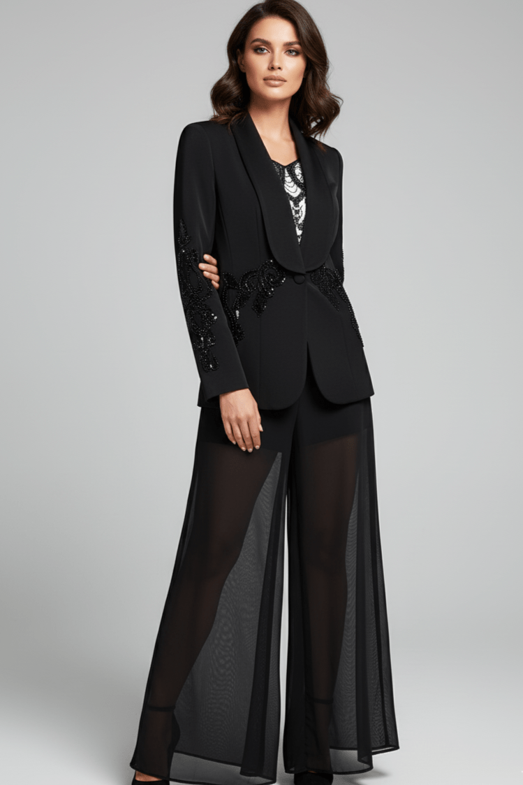 Veyra Sequin Blazer & Sheer Pants Set by Shine | 2 piece long set from Luxe Lane | SKU: -1 | Barcode:  | Options: Black S | Woman wearing a black suit with sheer pants on a gray background