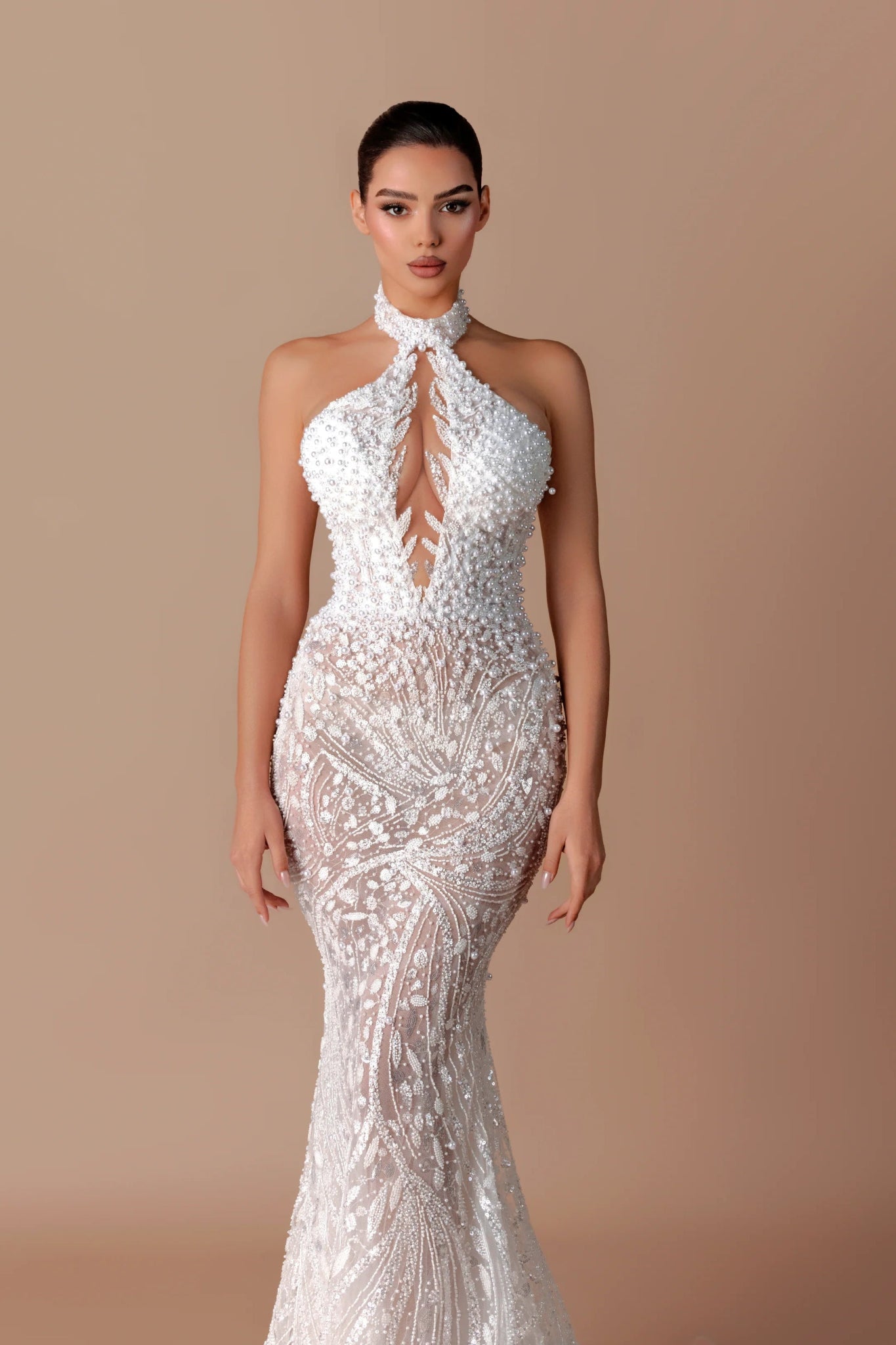 White Sequin Halter Backless Mermaid Evening Gown by Luxe Lane | mermaid gown from Luxe Lane | SKU: W11508-1 | Barcode:  | Options: White XS(0) | Woman wearing a white beaded evening gown on a beige background